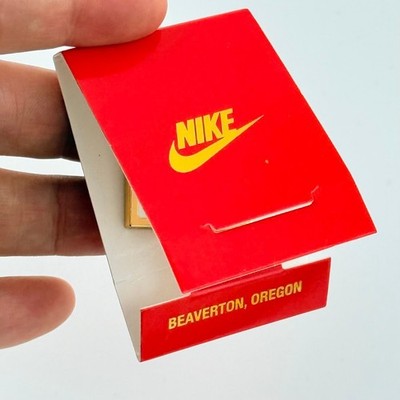 Vintage Nike Beaverton Oregon Gold Tone Swoosh Lapel Pin in Matchbook