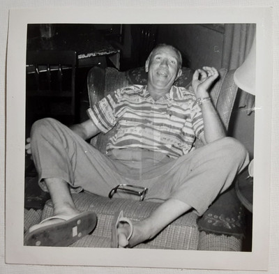 Happy Old Man Sits Spread Eagle w/ Glasses in His Crotch: 1950's Snapshot Photo