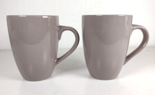 2 beige/Taupe  Sainsbury's mugs 11cm tall, 8cm wide
