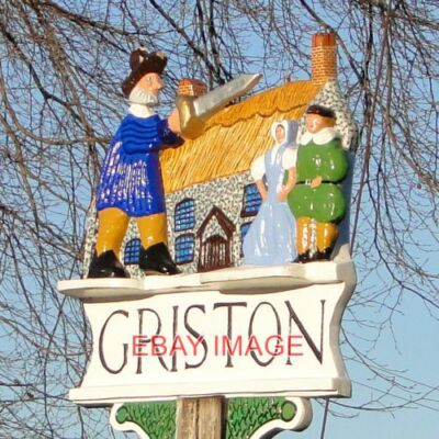 PHOTO  GRISTON VILLAGE SIGN (2) THAT'S ONE HELLUVA KNIFE HE'S GOT THERE. BASED O
