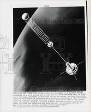 1963 Press Photo Drawing of weight suspended on spring holding satellite