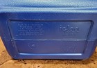 Blue and white vintage Igloo box with silver lid, engraved with “1963 is a trademark registered in the US Patent Office.”
