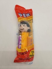 PEZ PEANUTS EDITION LUCY WITH ORANGE BASE AND FEET NEW SEALED