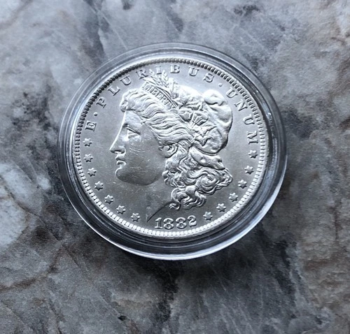1882-O/S MORGAN SILVER DOLLAR IN AU CONDITION.