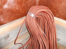 One pair of 50" long 1/8" wide rust colored rawhide leather boot / shoe laces.