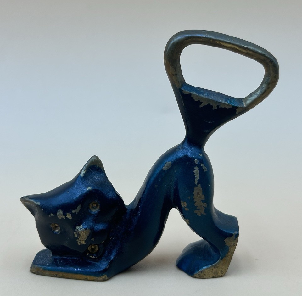 A sculptural Israeli-made Hakuli cat bottle opener — a genuinely rare, artisan-crafted object that's as much desk sculpture as bar tool.