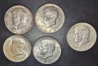 Silver kennedy half dollar lot. Four 1964 and one 1967. Five coins