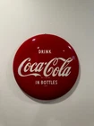 Vintage original “Drink Coca-Cola In Bottles” button sign from the early 1960s.