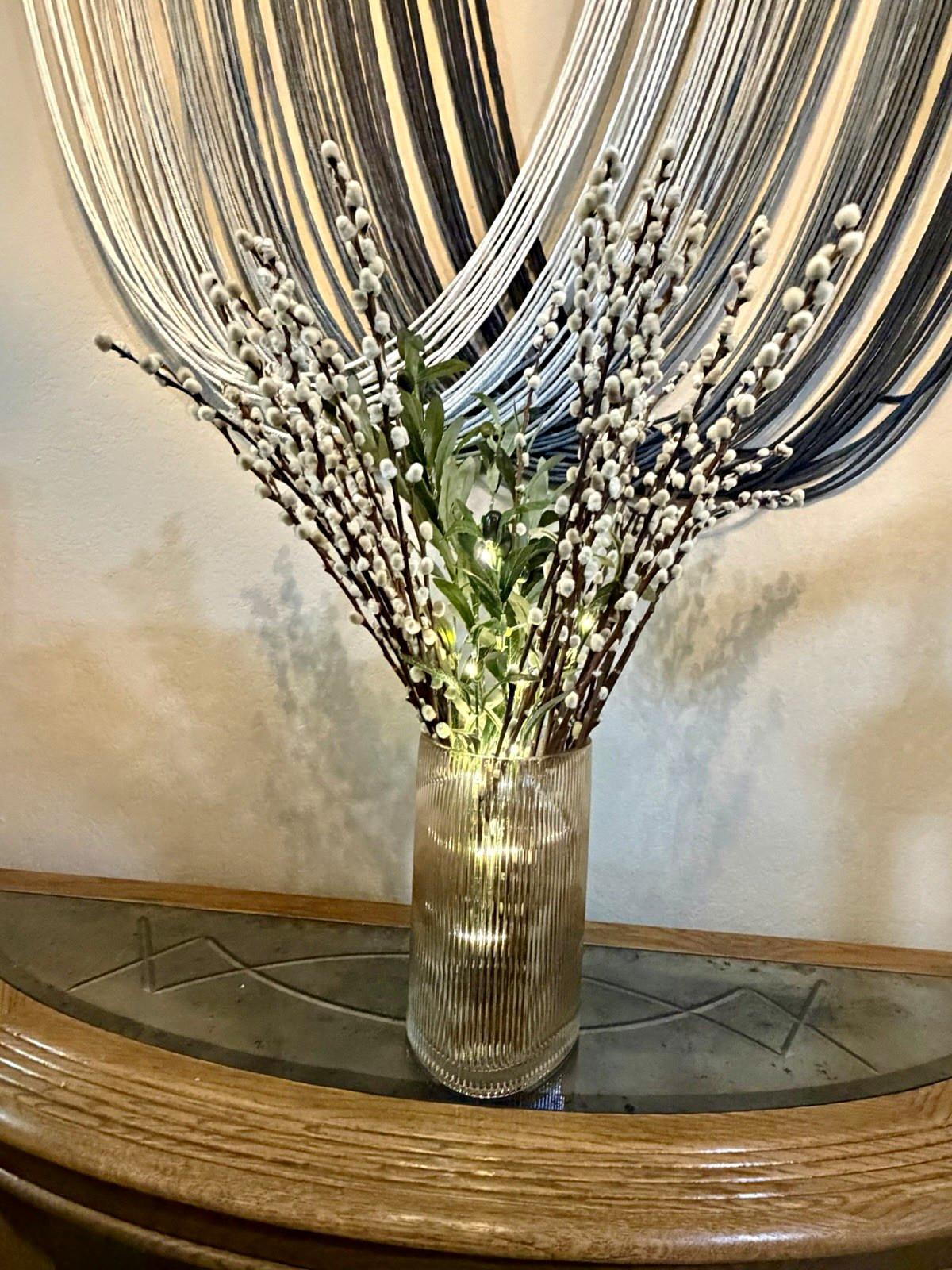 Ribbed smoked glass art vase on a white background.