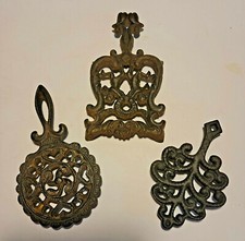 3 CAST IRON TRIVETS ONE IS A "WILTON"