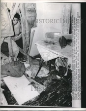 1953 Press Photo Mrs Sally Swift assessing damage to her kitchen