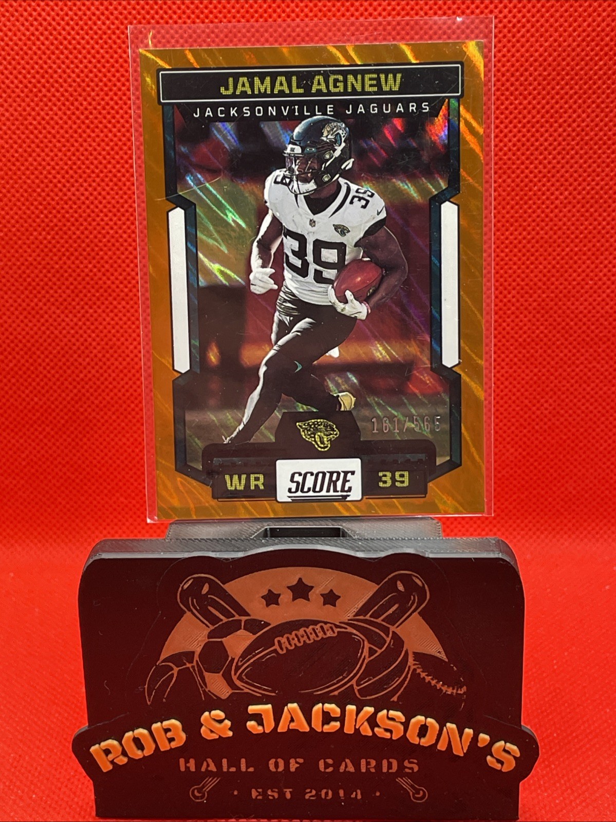 JAMAL AGNEW 2023 SCORE ORANGE LAVA SP #25 (/565) JAGUARS