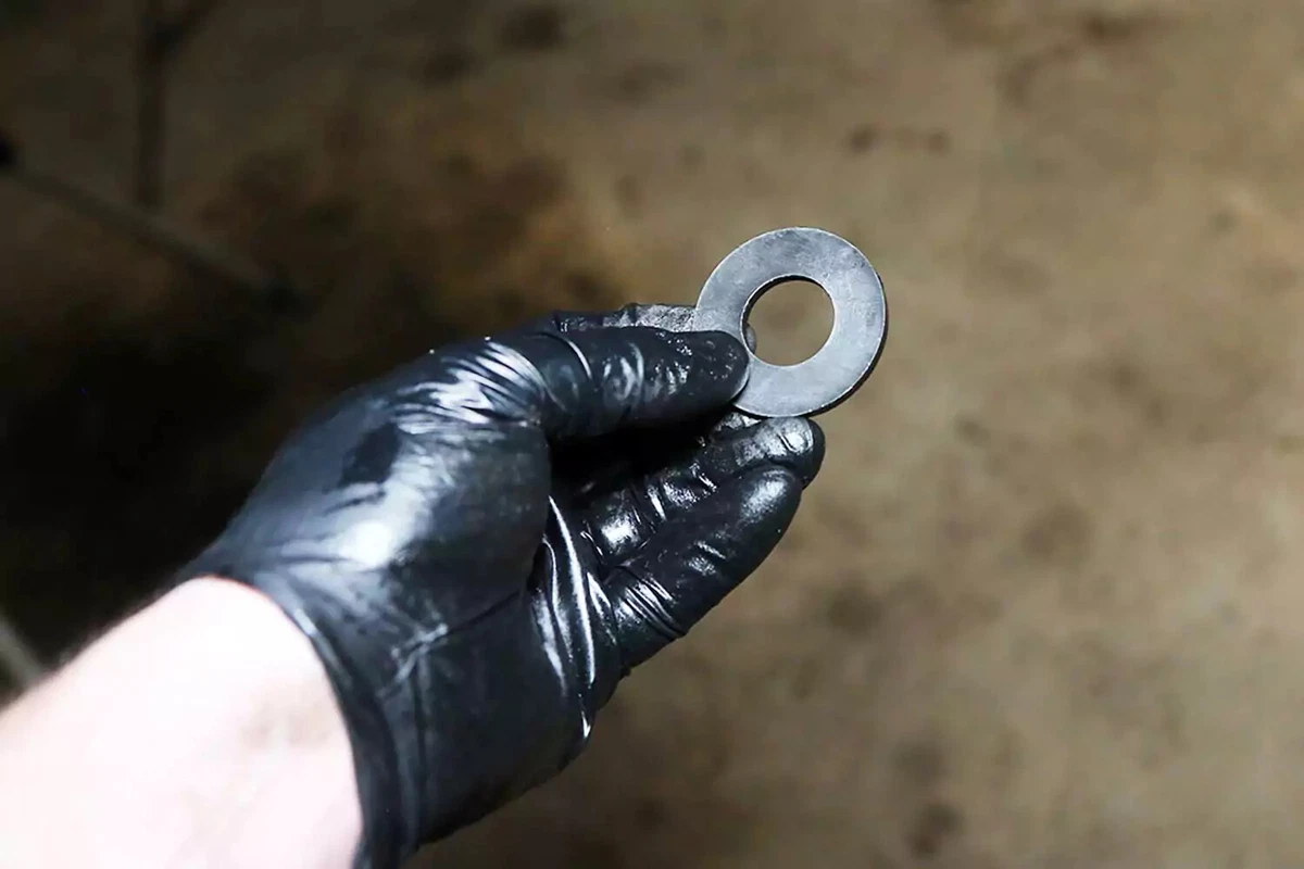 A mechanic holds an automatic transmission filter magnet.