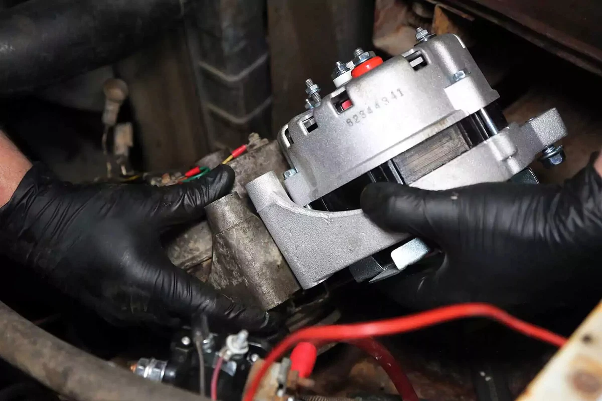 New and old alternators together in a vehicle.