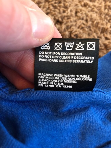 White EUC vintage 1995 90s POW MIA Never Forgotten stamp T shirt with blue ink label showing washing instructions.
