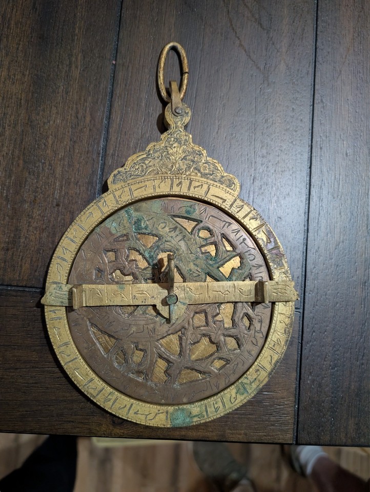 A handmade 18th-century Persian astrolabe with three engraved disks — a literal piece of astronomical history that doubles as stunning wall or shelf art.