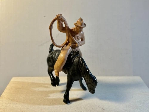 Marx 1950's 60mm plastic Chubby Cowboy with lasso on black bucking bronco.