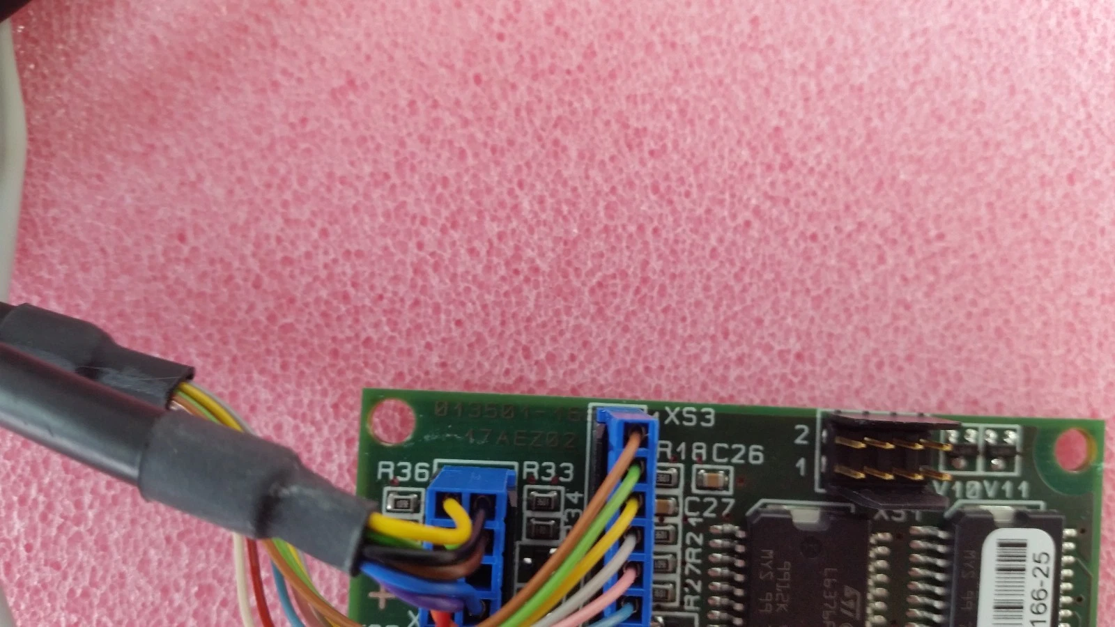 Silkscreen marking 013501-16 and 17AEZ02 on the Brooks load port board, with blue harness connectors