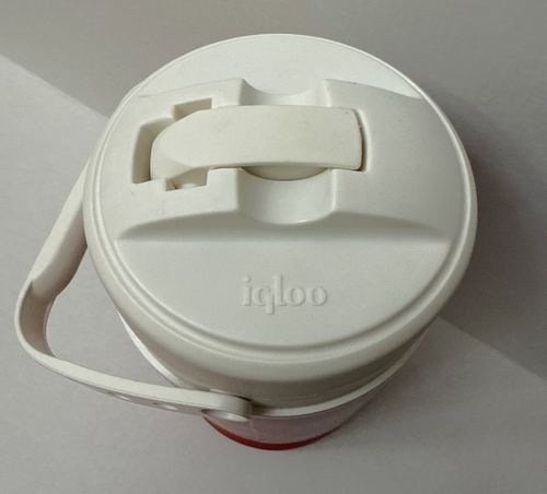 White vintage NWT Igloo 1/2 gallon cooler with black latch, side handle, and embossed logo on top.