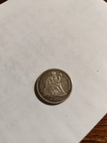 1883 Seated Liberty Dime In VG To XF Condition.