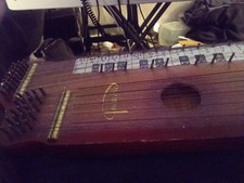 Pianonette Antique musical instrument has bowed melody strings and strummed of p