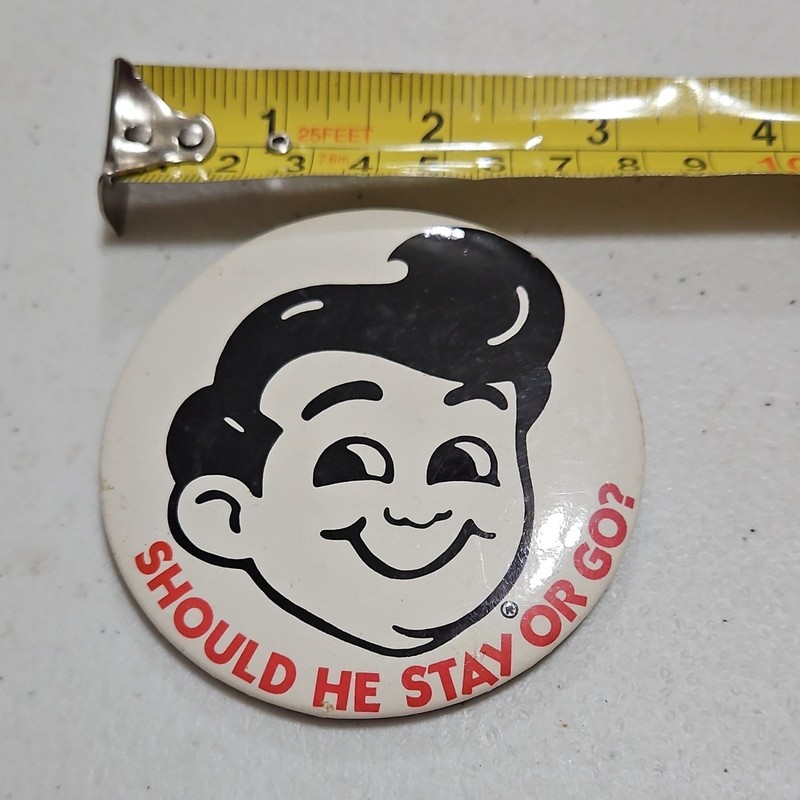 Vintage Advertising Pinback Button "Should He Stay or Go?" Smiling Face 2.25"