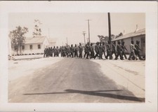 WW2 Photo of Soldiers Marching on Base Road Past Barracks and Utility Poles