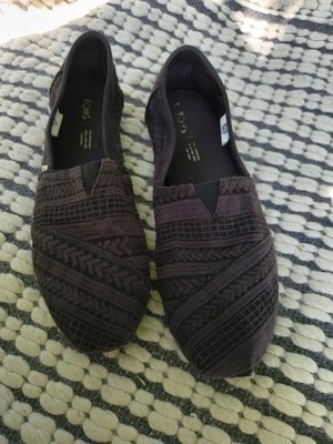 TOMS Alpargata slip-on flats featuring a textured arrow embroidery pattern