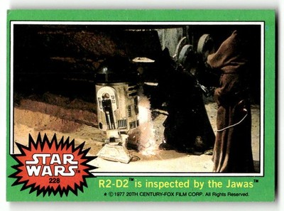 1977 Topps Star Wars #228 R2-D2 is inspected by the Jawas
