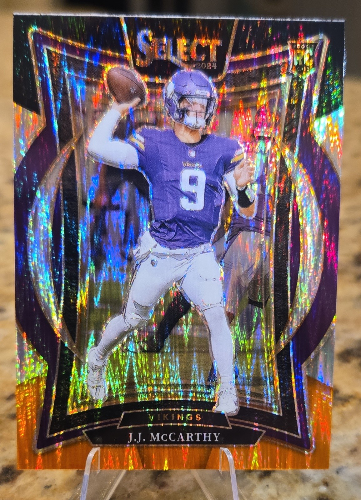 2024 Panini Select - Concourse J.J. McCarthy #24 Black & Orange Shock Prizm (RC)