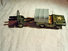 10 INCH TOTAL  JAPANESE TIN MILITARY JEEP TOY WITH TOWED TWIN BARRELED CANON