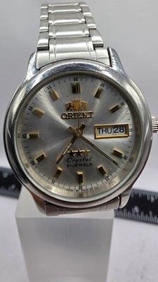 Orient Pm07-c0 Ca Crystal / Tri-Star 21J Automatic Day Date Wristwatch Stainless