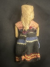 This tiny item is a handcrafted Guatemalan worry doll, roughly 2 inches tall.