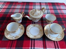 Vintage Noritake china tea set with gilded motifs, excellent condition.