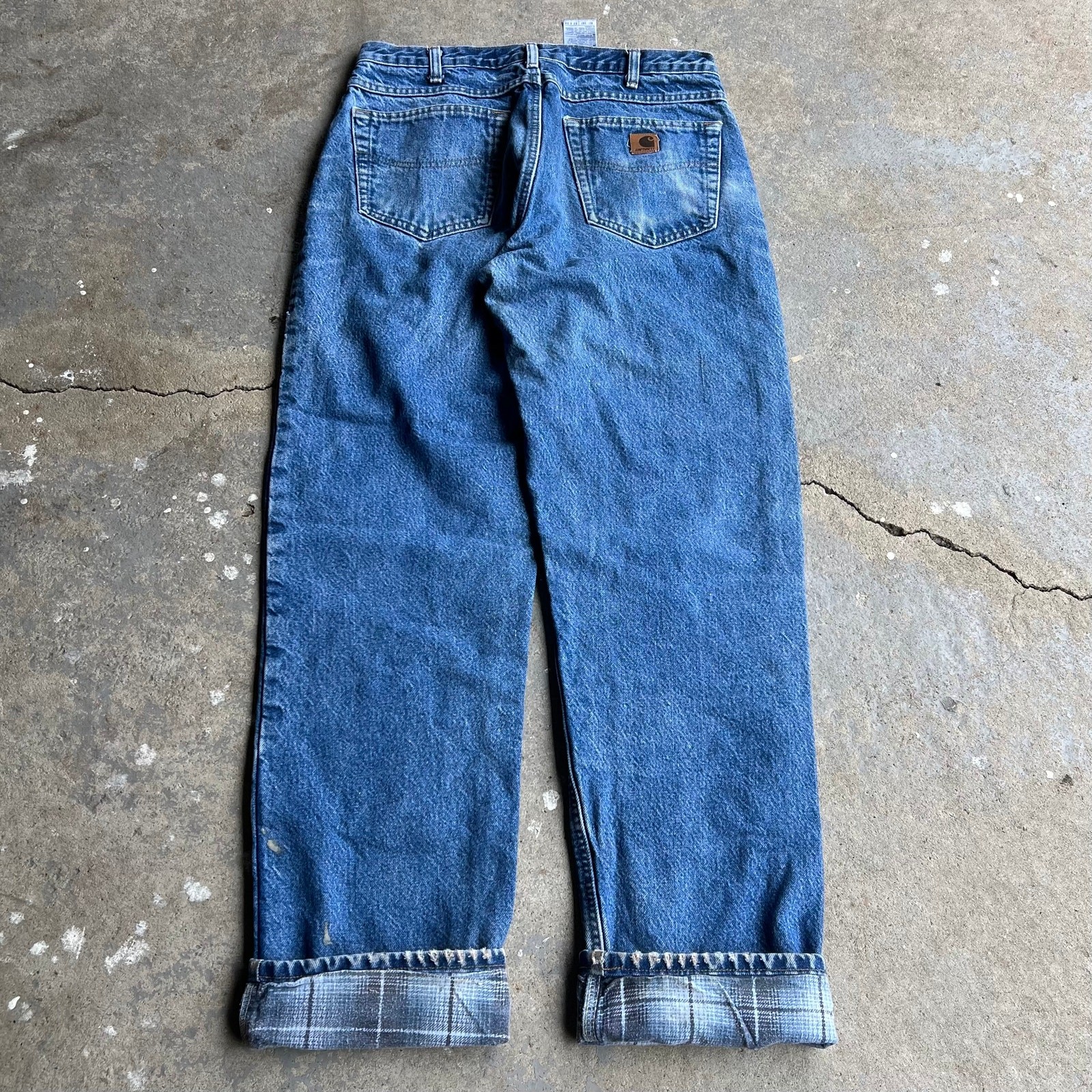 Vintage Carhartt flannel-lined faded blue denim carpenter work pants