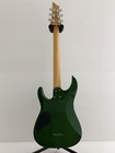 Green SCHECTER PA-SW/TH/See-Thru electric guitar with silver hardware and tapered back on white stand.