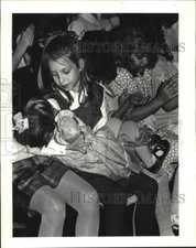 1988 Press Photo Erica Bales holds friend at St. John Theatre Christmas Pageant