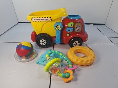 Toy V Tech Drop And Go Dump Truck With Working Sounds & A Load Of 5 Baby Toys.