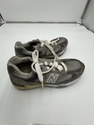 Grey New Balance 991 size 7 with white laces, tan midsole, and large white “N” logo on side.