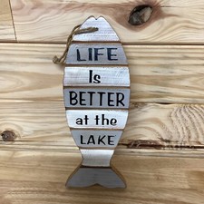 Fish shaped sign. Life is better at the beach. Colors of gray and white.