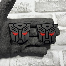 Car Fender Badge 2x Autobot Transformer Mask 2 Inches Emblem Matte Black Color