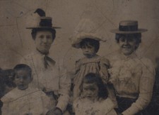 PORTRAIT OF TWO SMILING WOMEN W/ THEIR CHILDREN IN STUDIO BEACH SCENE