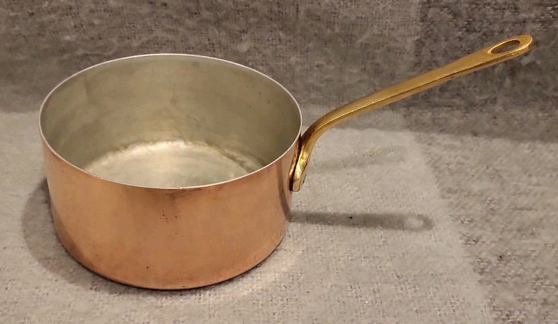 Small vintage French copper saucepan with brass handle and tin lining.