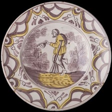 Delft Purple and Yellow Majolica Charger with a Beggar Dutch, 1675-1700