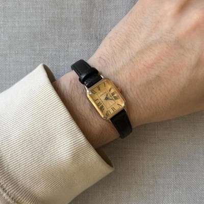 Vintage classic black leather watch with gold face.