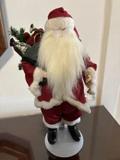 Santa 17 Inch Doll With Imitation  Fur Trimmed Outfit comes with metal stand. 
