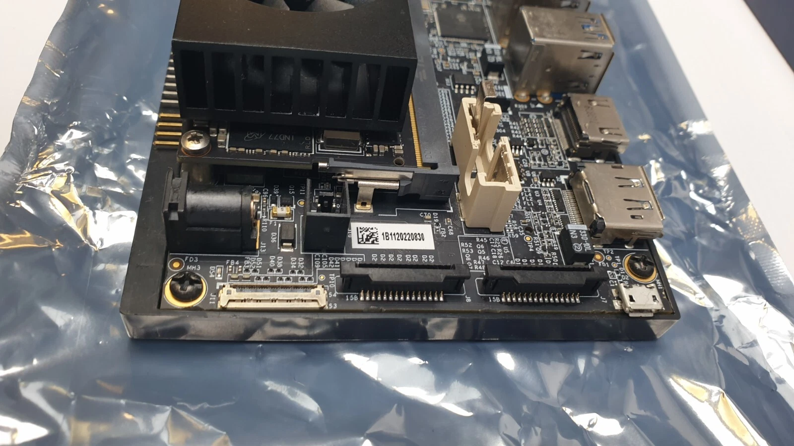Side of the carrier board with DC jack, camera connectors and serial label