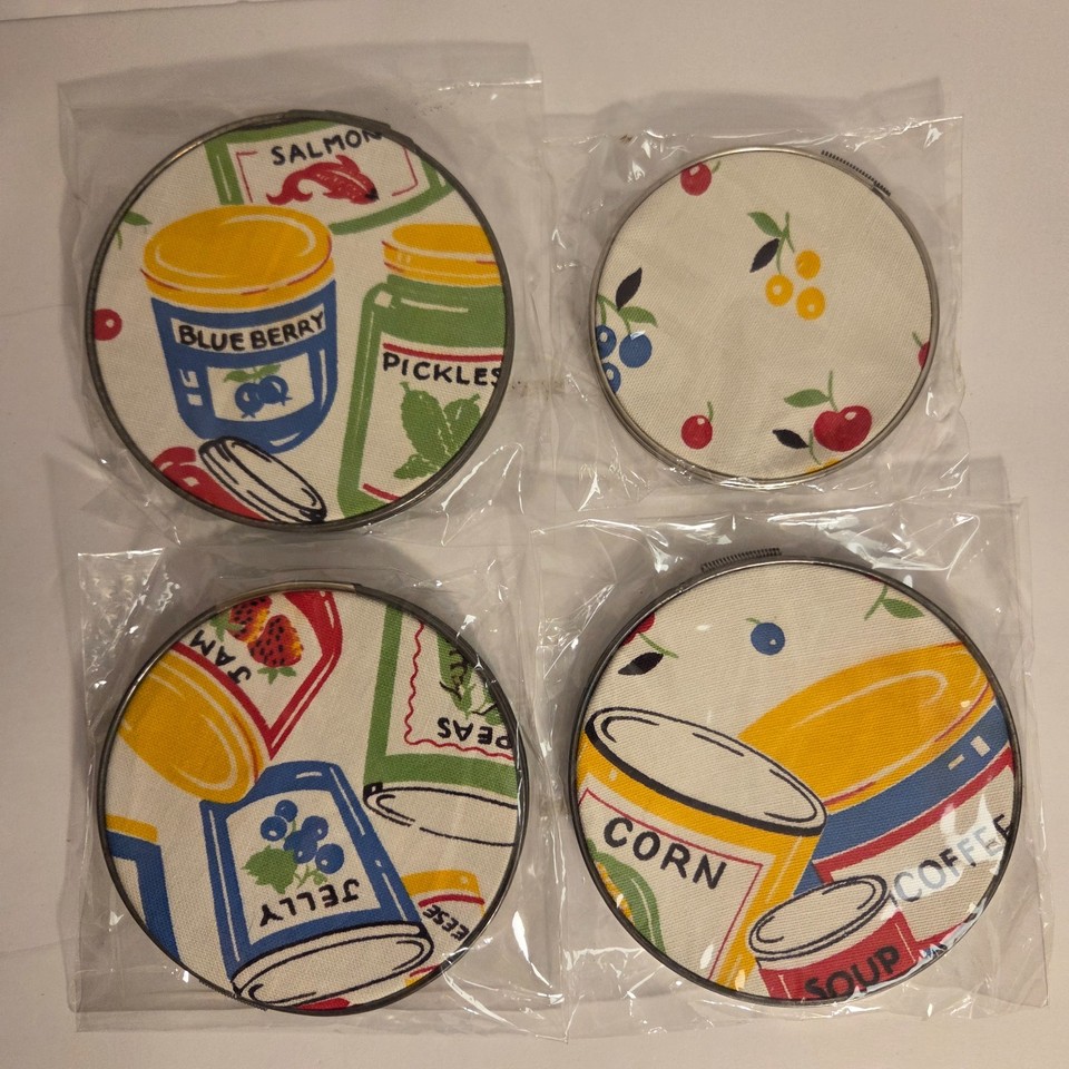 Vintage kitchen tea towels mounted in metal embroidery hoops as wall art — a clever, crafty repurposing of retro textiles that looks like it belongs in a design magazine.