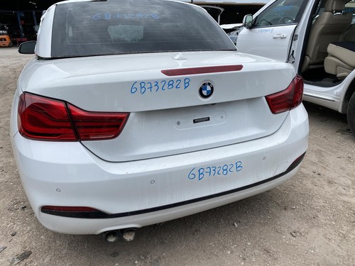 White 2018 BMW 430I rear door mirror with blue handwritten text and red BMW logo on black panel.