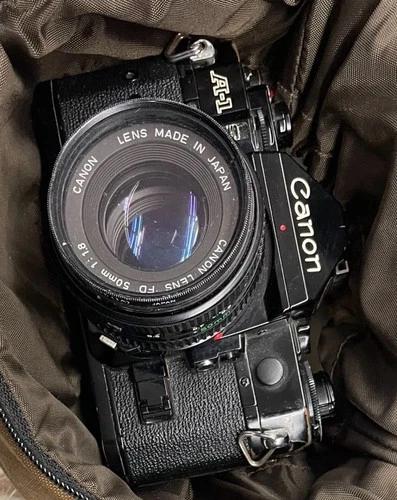 Canon A-1 35mm SLR Film Camera with 50mm f/1.8 Lens Black wit accessories 